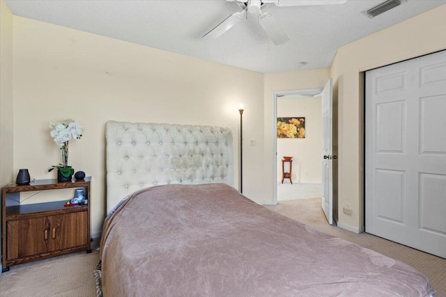 carpeted bedroom with ceiling fan and a closet