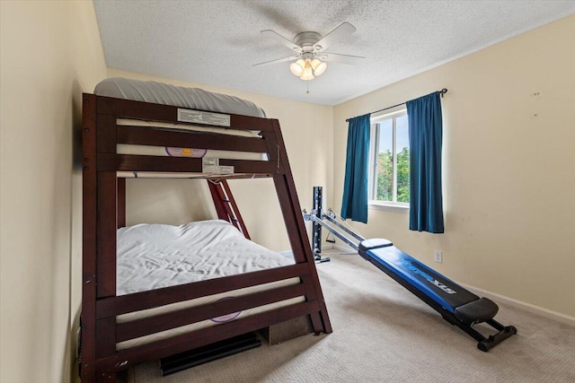 carpeted bedroom with ceiling fan and a textured ceiling