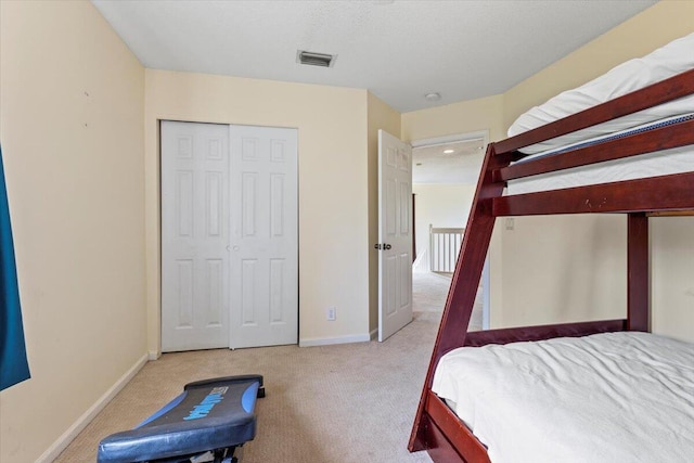 carpeted bedroom with a closet