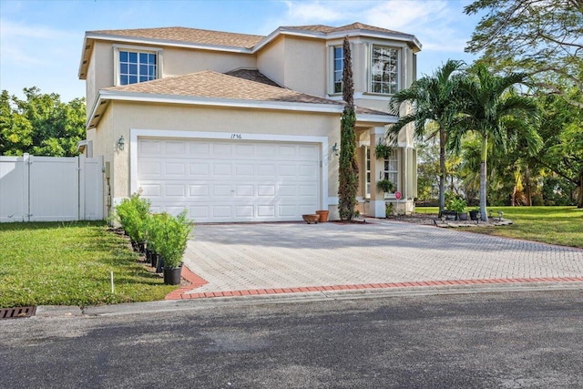 view of front of home with a garage and a front lawn