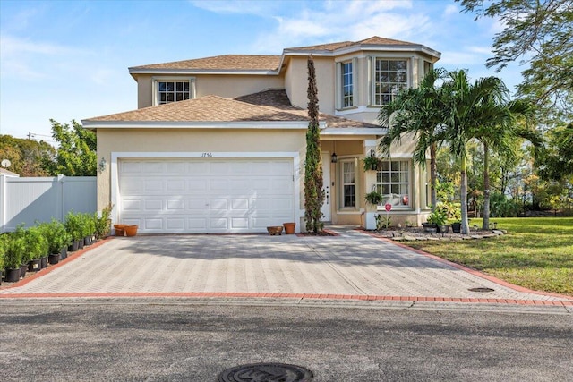 view of front of home with a front yard and a garage