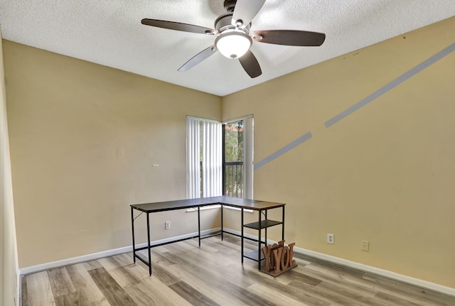 home office featuring ceiling fan, a textured ceiling, and light wood-type flooring