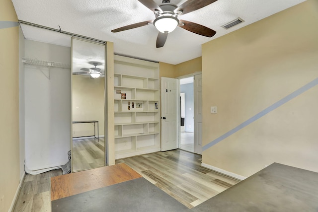 interior space with hardwood / wood-style floors and a textured ceiling