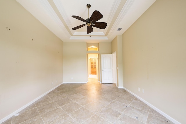 empty room with ceiling fan, crown molding, and a tray ceiling