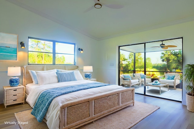 bedroom featuring ceiling fan, dark hardwood / wood-style flooring, multiple windows, and vaulted ceiling