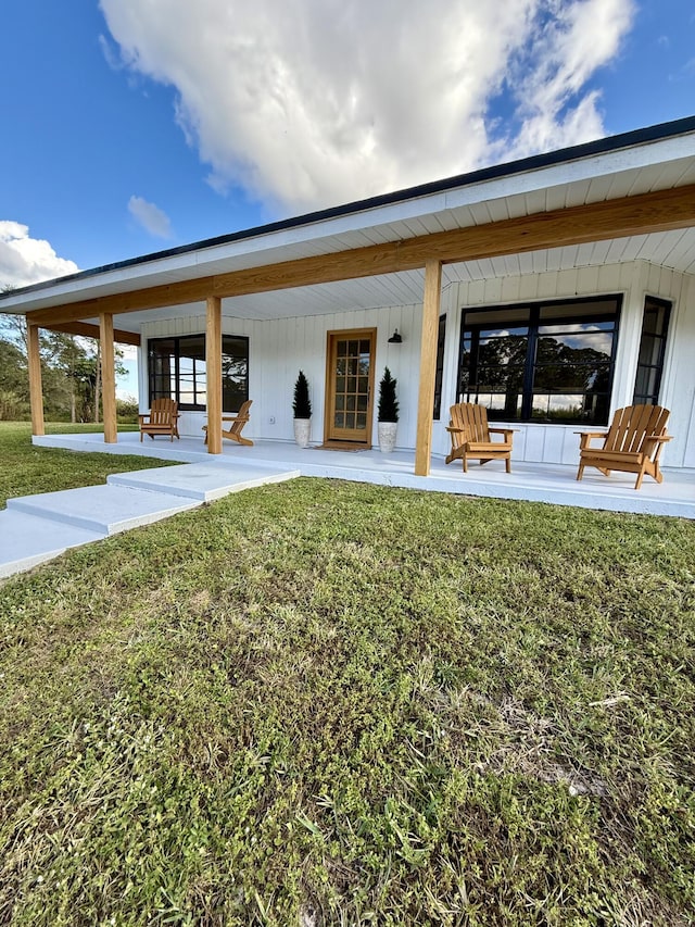 rear view of property featuring a yard