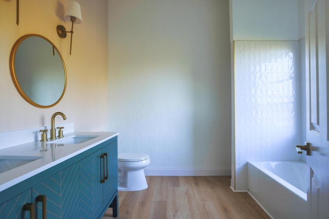 bathroom with hardwood / wood-style floors, vanity, and toilet