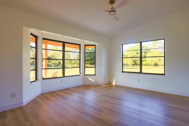 spare room with ceiling fan, lofted ceiling, and light hardwood / wood-style flooring