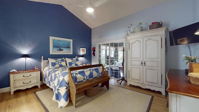 bedroom featuring ceiling fan, vaulted ceiling, and light wood-type flooring