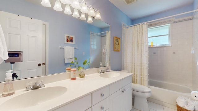 full bathroom with tile patterned flooring, shower / bath combo, vanity, and toilet