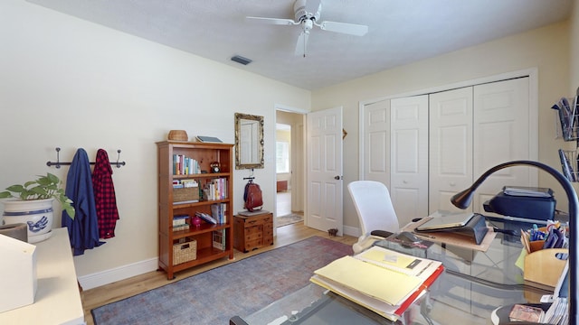 home office featuring hardwood / wood-style flooring and ceiling fan