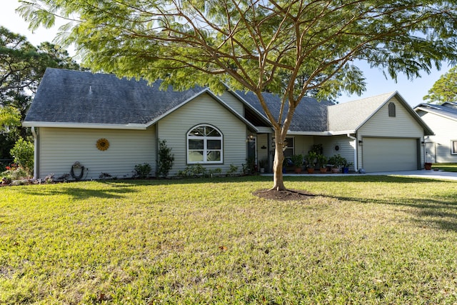 ranch-style house with a garage and a front lawn