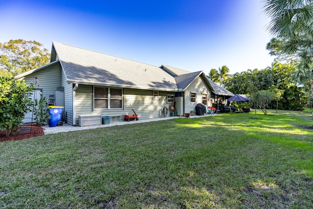 rear view of house with a yard