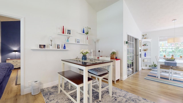 interior space with light hardwood / wood-style floors and lofted ceiling