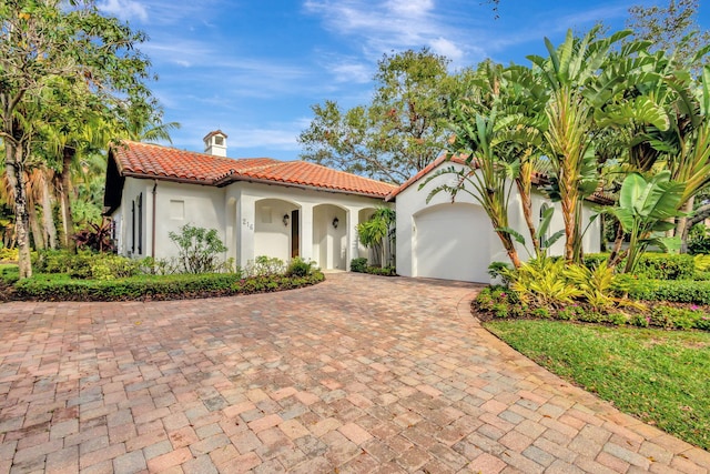 mediterranean / spanish house featuring a garage