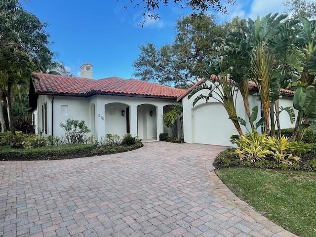 mediterranean / spanish-style house featuring a garage