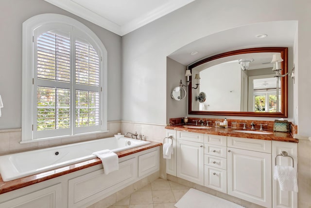 bathroom with tile patterned floors, vanity, ornamental molding, and a tub