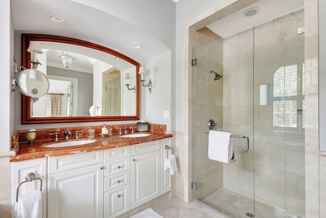 bathroom with crown molding, a shower with door, and vanity