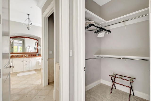 spacious closet featuring light tile patterned flooring