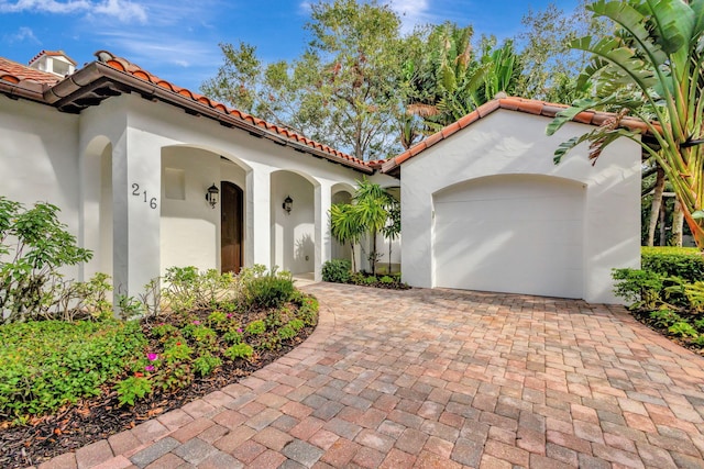 mediterranean / spanish-style home with a garage