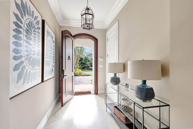 doorway featuring crown molding and a notable chandelier