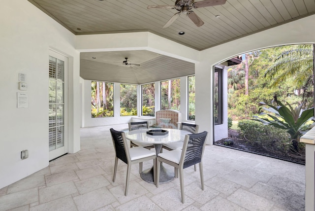 sunroom / solarium with ceiling fan and wood ceiling