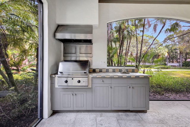 view of patio / terrace with exterior kitchen, sink, and grilling area