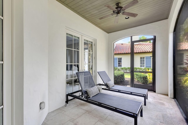 workout room featuring ceiling fan, wood ceiling, and french doors