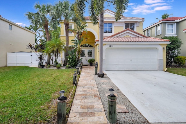 mediterranean / spanish-style home with a garage and a front yard