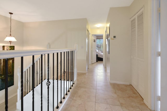 corridor with light tile patterned floors