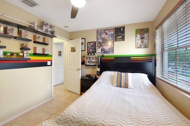 tiled bedroom with ceiling fan