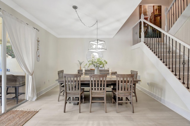 dining space featuring crown molding and an inviting chandelier