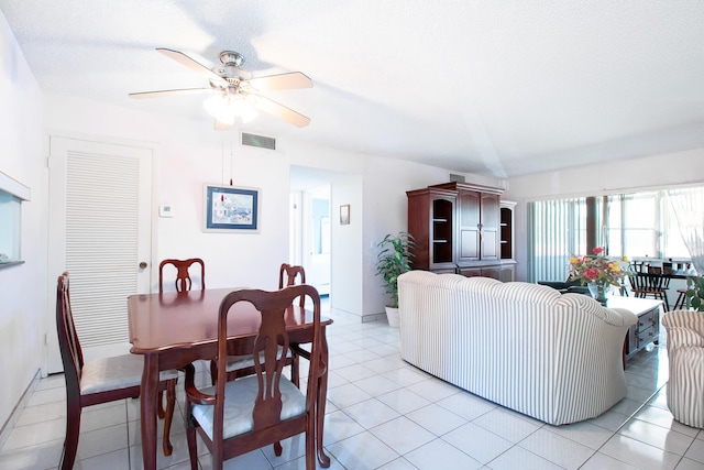 living room with light tile patterned floors, ceiling fan, and visible vents