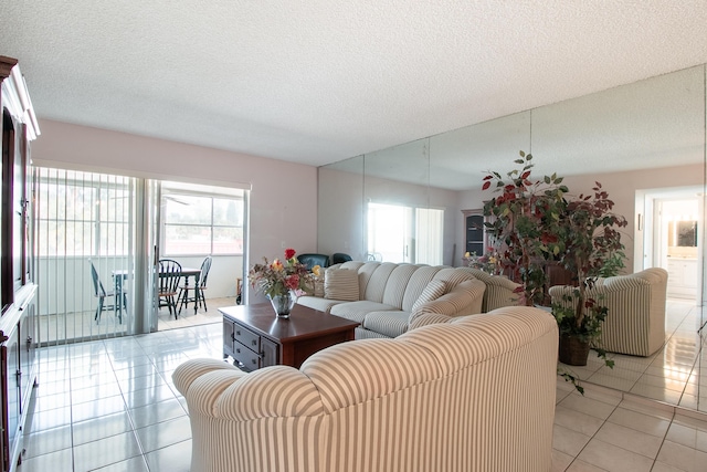 tiled living room featuring a textured ceiling