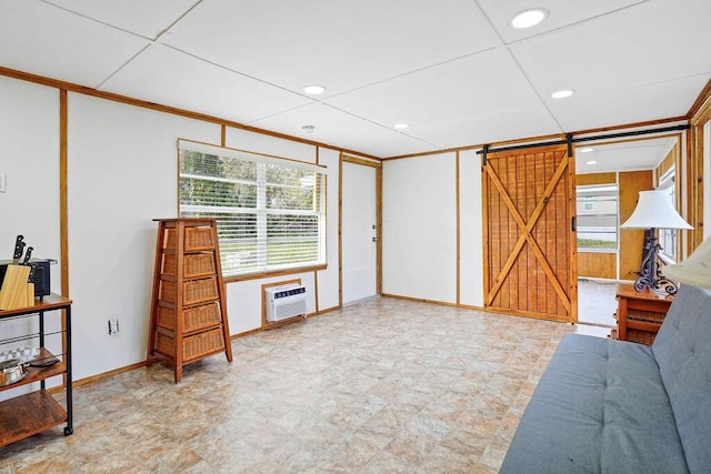 interior space featuring a barn door and a wall unit AC