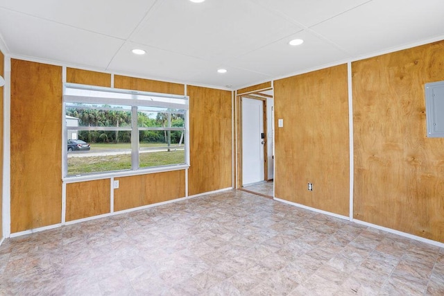 empty room with wood walls and electric panel