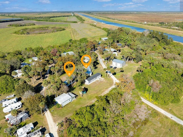 birds eye view of property featuring a water view and a rural view