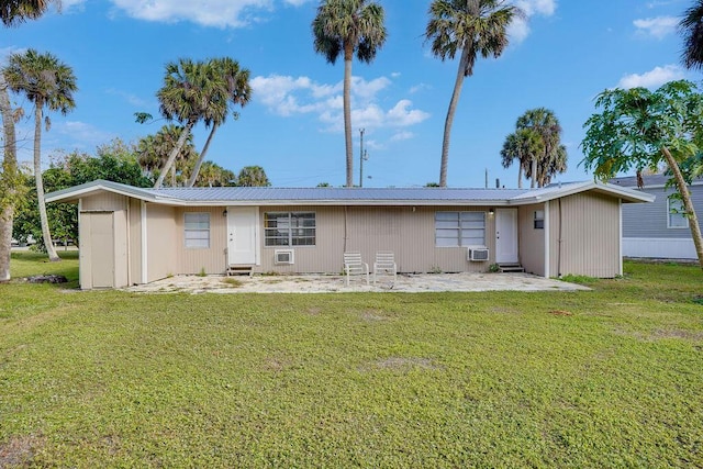 back of property featuring a lawn