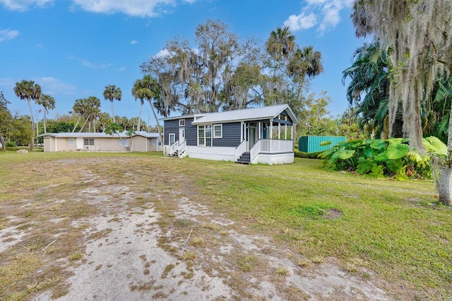 manufactured / mobile home featuring a front lawn and covered porch