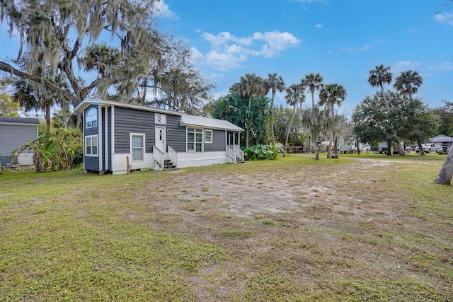 back of property featuring a lawn