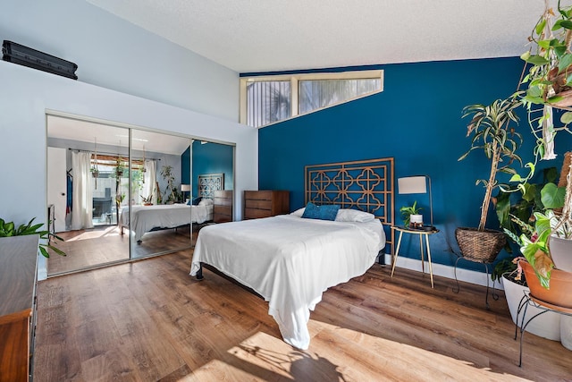 bedroom featuring wood-type flooring, a closet, and a textured ceiling