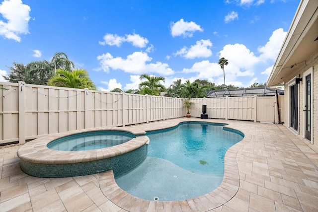 view of pool featuring an in ground hot tub and a patio area