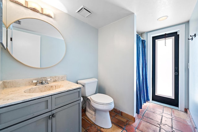 bathroom with vanity and toilet