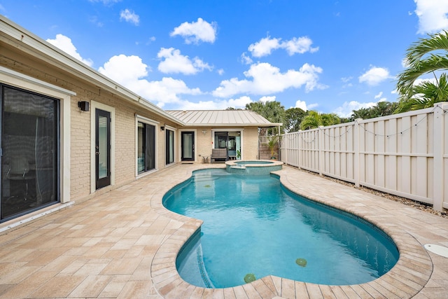 view of pool featuring an in ground hot tub and a patio area