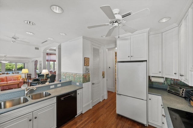 kitchen featuring sink, white refrigerator, white cabinetry, and black dishwasher