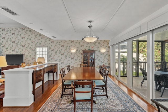 dining area with hardwood / wood-style floors and ornamental molding