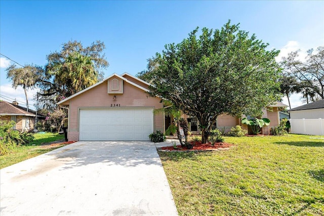 view of front of house featuring a garage and a front lawn