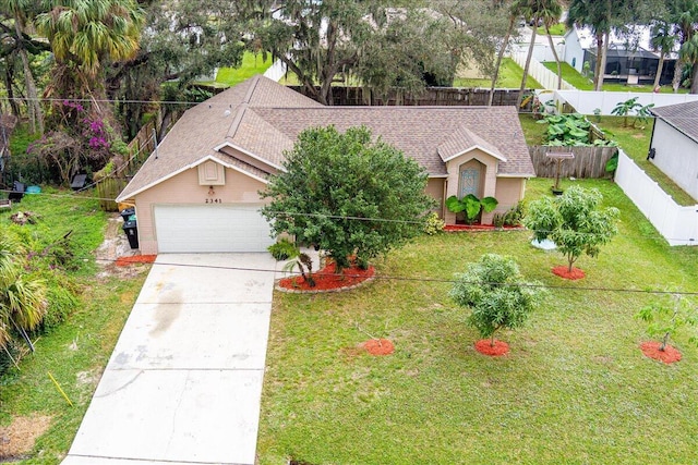 ranch-style home featuring a front yard and a garage