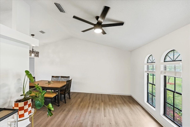 dining area with a wealth of natural light, ceiling fan, light hardwood / wood-style floors, and vaulted ceiling