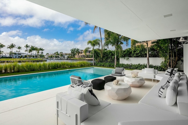 view of pool featuring a patio and a water view